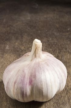 Ripe fresh garlic on a brown wooden table