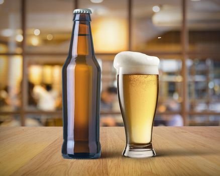 beer bottle and mug of beer on the bar