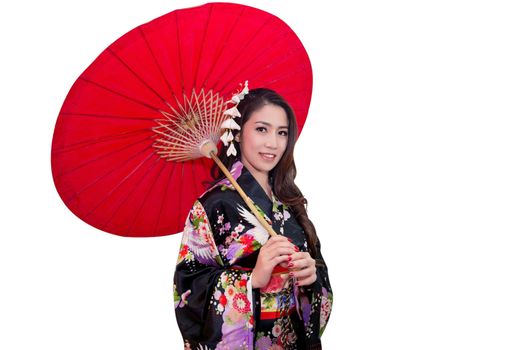 Beautiful young asian woman wearing traditional japanese kimono with red umbrella isolated on white background.