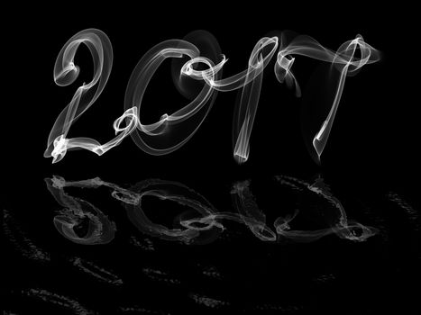 Happy new year 2017 isolated numbers with water reflection written with smoke or fire on black background.