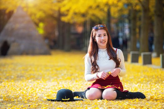 Beautiful Girl with Yellow Leaves in Nami Island, Korea. Nami island in autumn.