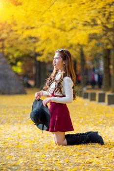 Beautiful Girl with Yellow Leaves in Nami Island, Korea. Nami island in autumn.