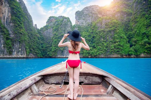 Beautiful girl in red bikini on boat.