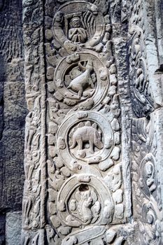 sculpted stone depicting a dinosaur at the ancient Ta Prohm temple at Angkor Wat, Siem Reap, Cambodia.