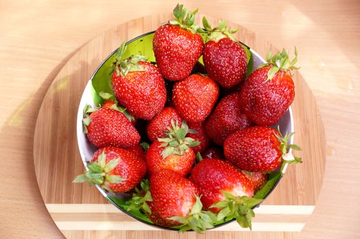 Fresh crop of strawberry from the Russian giving in a transparent salad bowl