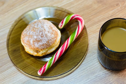 on the plate of a bun and candy along with coffee.