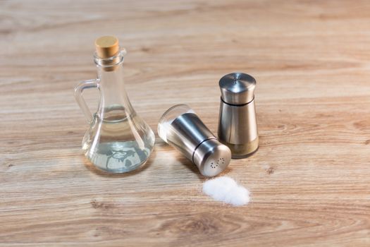 salt and pepper shakers on rustic wooden table.