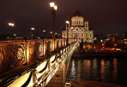 Night landscape the bridge through the Moskva River and the Cathedral of Christ the Saviour in the city of Moscow