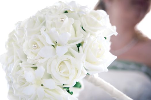 wedding bouquet in foreground and a blurred background