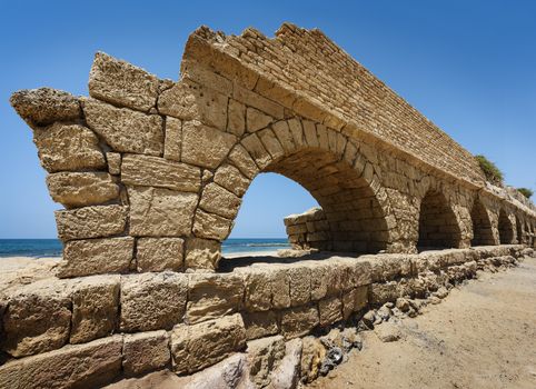 Ancient Roman aqueduct in Ceasarea at the coast of the Mediterranean Sea, Israel built by Herod, Israel