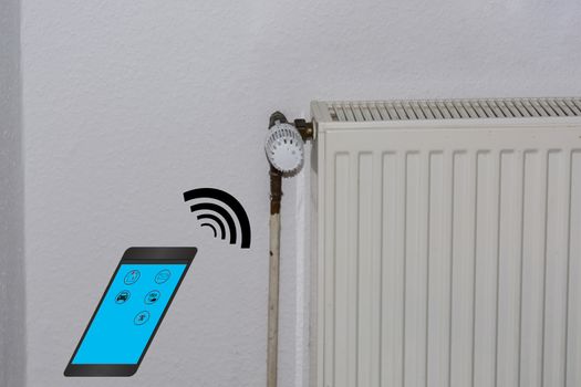 Smart Home Control concept. Temperature adjustment of heating via smartphone.