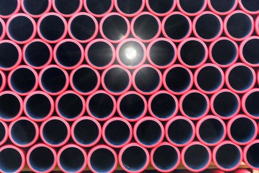 Stockyard of various tubes and pipes at a construction site.