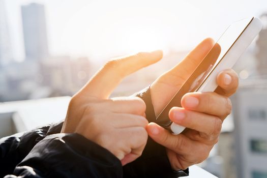 close up of hand typing on phone
