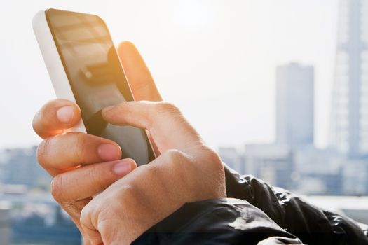 close up of hand typing on phone