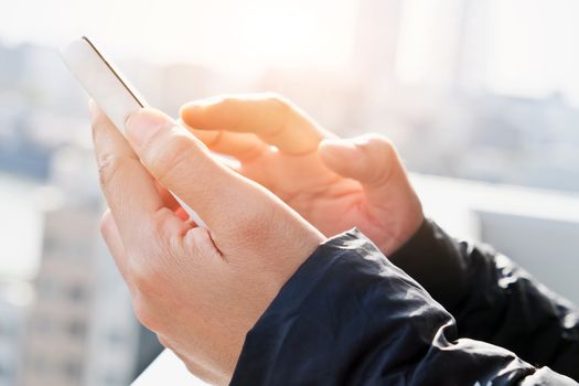 close up of hand typing on phone