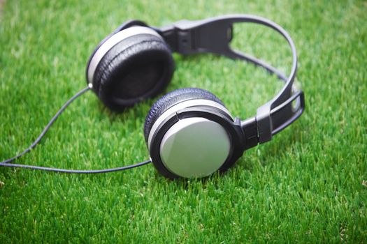 Headphones in a grass. Horizontal photo