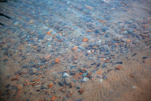 Underwater pebbles in the river. Close-up photo