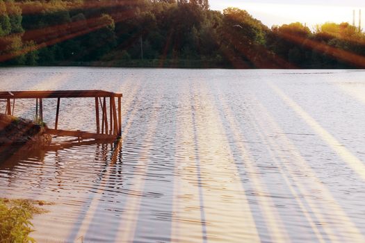 Magic pond. Composition of a pond and rays. Natural background