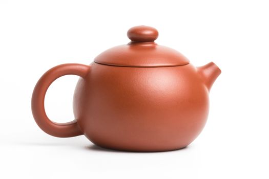 Brown small earthenware teapot with closed lid isolated on white background