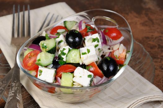 greek salad orzo pasta with black olive, red onion and cucumber, cherry tomatoes, feta and herbs