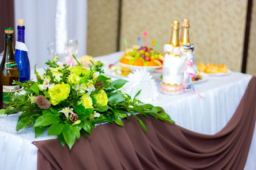 the wedding table decorated in flowers for newlyweds