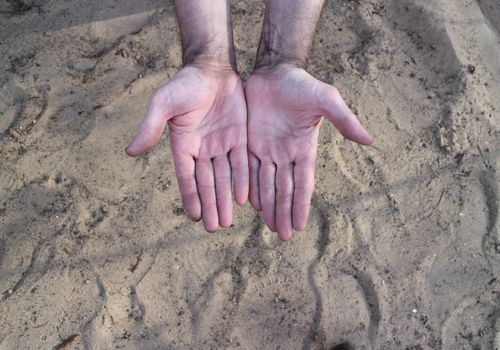 worker hands palms soiled with soot close to