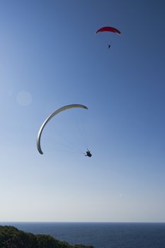 Paragliders in the blue sky.