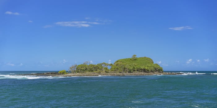 Panoramic landscape view of Old Woman Island or Mudjimba Island Sunshine Coast Queensland surrounded by blue sky and Pacific ocean