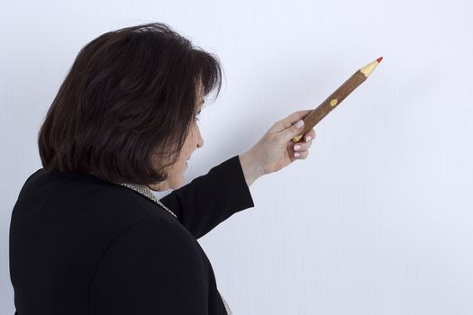 Senior business woman with a pencil on a white background