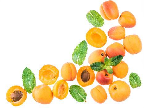 Apricot and mint leaves isolated on white background with copy space. Food background, healthy food, superfood, diet, detox concept. Top view or flat lay