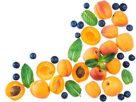 Apricot, blueberries and mint leaves isolated on white background with copy space. Food background, healthy food, superfood, diet, detox concept. Top view or flat lay