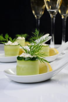 Cucumber canape with ricotta and lemon slice close-up. 