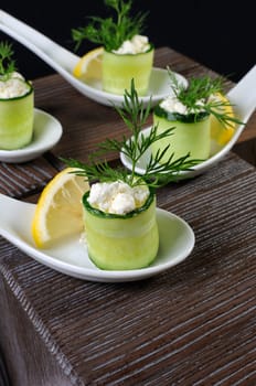 Cucumber canape with ricotta and lemon slice close-up. 