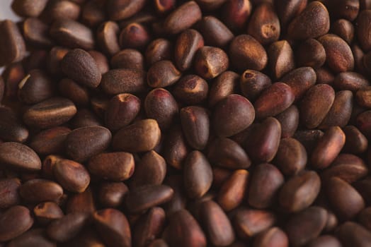 Pine nuts in shells of ciberian cedar as a background. Macro.