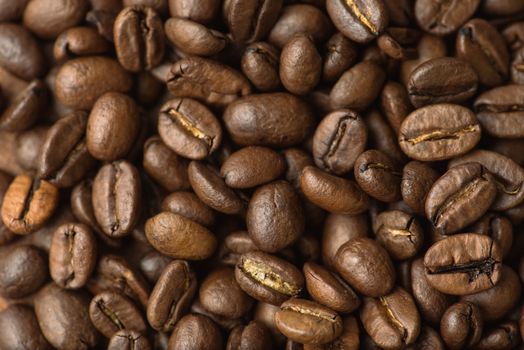 Brown coffee beans, closeup macro for background and texture.