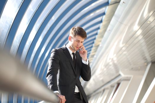 Businessman talking on the phone in modern building