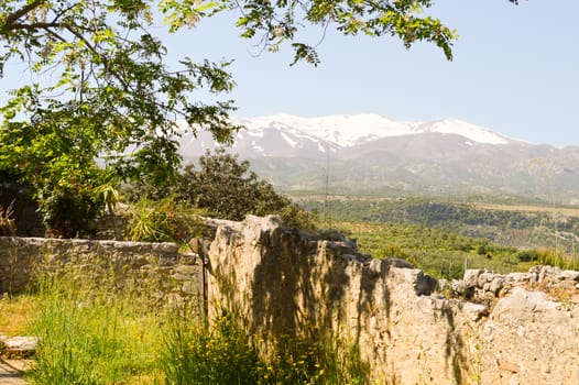White mountains of the psilotoris in Crete with in the foreground an old wall of abbey