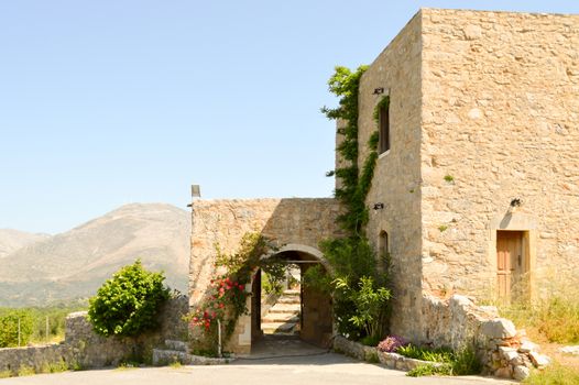 Entrance portico of an ancient abbey with the mountain in background on the island of Crete