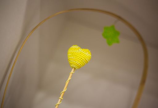 yellow embroidered heart on a stick