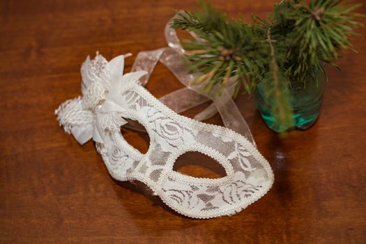 Christmas white mask and fir branch