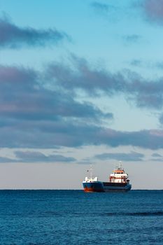 Blue bulk carrier sailing in still water