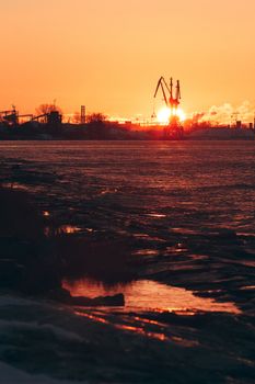 Hot winter sunrise over the cargo port in Riga