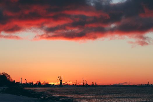 Hot winter sunrise over the cargo port in Riga
