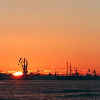 Hot winter sunrise over the cargo port in Riga