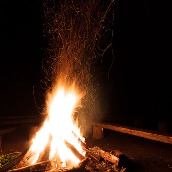 Campfire with flying sparks in the night