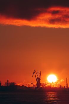 Hot winter sunrise over the cargo port in Riga