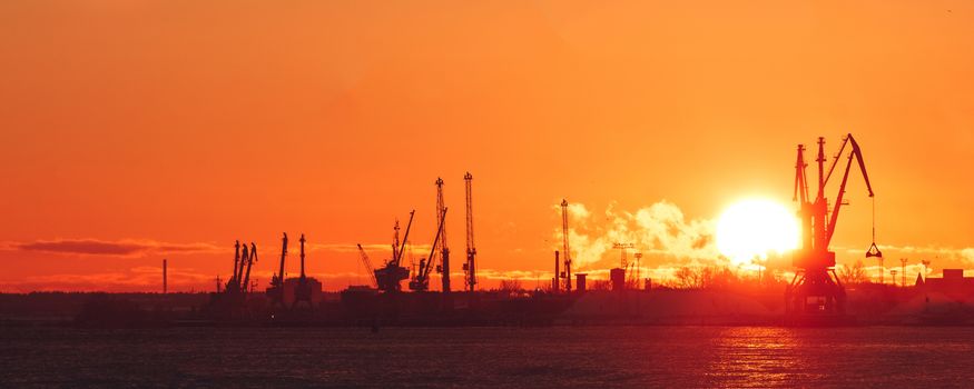 Hot winter sunrise over the cargo port in Riga
