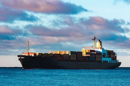 Modern black container ship moving from Baltic sea