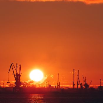 Hot winter sunrise over the cargo port in Riga