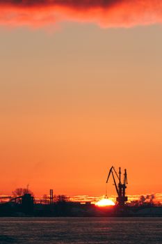 Hot winter sunrise over the cargo port in Riga